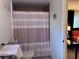 Bathroom with neutral striped shower curtain and tile floors at 10102 Missy Ct, Tampa, FL 33615