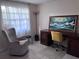 Cozy bedroom with a stylish chair, desk, and a picturesque painting at 10102 Missy Ct, Tampa, FL 33615