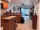 A view of the kitchen featuring tile flooring, sliding glass doors, and an island at 10102 Missy Ct, Tampa, FL 33615
