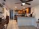 Bright kitchen featuring stainless steel appliances, tile flooring and light stained cabinets at 10102 Missy Ct, Tampa, FL 33615