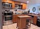 Traditional kitchen featuring stainless steel appliances, light cabinets, and tile floors at 10102 Missy Ct, Tampa, FL 33615