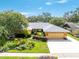 An aerial view of the lovely single-story home with a well-maintained lawn and mature landscaping at 104 Foxwood Dr, Brandon, FL 33510