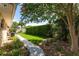 Backyard landscaping showcasing grass, mulch, pavers and greenery at 104 Foxwood Dr, Brandon, FL 33510