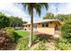 Lush backyard featuring mature landscaping, a well-maintained lawn, and a cozy patio area for relaxation and entertainment at 104 Foxwood Dr, Brandon, FL 33510