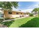 Charming backyard featuring lush green grass, mature trees, and a quaint patio area, perfect for outdoor enjoyment at 104 Foxwood Dr, Brandon, FL 33510