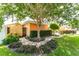 A peaceful backyard scene featuring a beautiful tree, lush shrubbery and a stepping stone pathway at 104 Foxwood Dr, Brandon, FL 33510