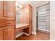 Bathroom vanity with wood cabinets, drawers, countertop, and a walk-in closet with white shelving at 104 Foxwood Dr, Brandon, FL 33510