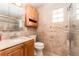 Full bathroom with tiled walls, glass shower, and wooden vanity at 104 Foxwood Dr, Brandon, FL 33510