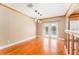 Dining room with hardwood floors, modern pendant lighting, and access to the backyard through glass doors at 104 Foxwood Dr, Brandon, FL 33510