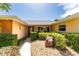 A cozy front entrance featuring a walkway surrounded by mature bushes and a well-maintained lawn at 104 Foxwood Dr, Brandon, FL 33510
