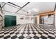 Spacious garage with checkerboard tile flooring, storage cabinets, and access to laundry at 104 Foxwood Dr, Brandon, FL 33510