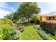 A beautiful, landscaped yard featuring lush greenery, mature trees, and colorful flowers at 104 Foxwood Dr, Brandon, FL 33510