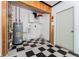Laundry room with checkerboard flooring and water heater at 104 Foxwood Dr, Brandon, FL 33510