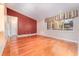 Bright living room featuring hardwood floors, neutral walls, and a large window with natural light at 104 Foxwood Dr, Brandon, FL 33510