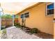 Charming side yard with brick pavers, mature plants, and a wooden gate, creating a private outdoor space at 104 Foxwood Dr, Brandon, FL 33510