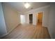 Large bedroom with crown molding, light hardwood floors and three doors to other rooms at 10409 Villa View Cir # 10409, Tampa, FL 33647