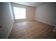 Bright bedroom with hardwood floors, a large window, and neutral walls, creating a serene atmosphere at 10409 Villa View Cir # 10409, Tampa, FL 33647