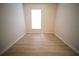 Inviting bedroom featuring hardwood floors and a bright window, creating a comfortable and well-lit space at 10409 Villa View Cir # 10409, Tampa, FL 33647