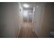 Hallway featuring wood-look flooring, arched entrances, and access to the laundry room at 10409 Villa View Cir # 10409, Tampa, FL 33647