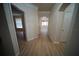 Hallway features wood-look flooring and an arched entrance to another room at 10409 Villa View Cir # 10409, Tampa, FL 33647