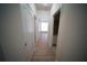 Hallway showcasing modern floors, multiple doors, and access to a bathroom, connecting the living spaces at 10409 Villa View Cir # 10409, Tampa, FL 33647