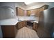 Modern kitchen with stainless steel appliances, wood cabinets, and white countertops at 10409 Villa View Cir # 10409, Tampa, FL 33647