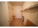 Spacious walk-in closet featuring wire shelving and wood-look flooring at 10409 Villa View Cir # 10409, Tampa, FL 33647