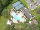 Aerial view of community amenities featuring a pool, tennis courts, and playground at 10842 Rolling Moss Rd, Tampa, FL 33647