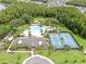 Overhead image showcasing community pool, tennis courts, clubhouse, and playground areas at 10842 Rolling Moss Rd, Tampa, FL 33647