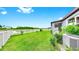 Well-maintained lawn and landscaping, complemented by a charming white picket fence at 10842 Rolling Moss Rd, Tampa, FL 33647