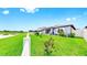Backyard showing a well-manicured lawn, patio, a lake, and a white fence at 10842 Rolling Moss Rd, Tampa, FL 33647