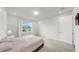 Bright bedroom with soft carpet, neutral walls, and a window with a scenic view at 10842 Rolling Moss Rd, Tampa, FL 33647