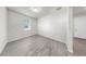 A clean and bright bedroom with wood-look floors and a window at 10842 Rolling Moss Rd, Tampa, FL 33647