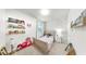 Charming bedroom with bookshelves, bow wallpaper, and natural light at 10842 Rolling Moss Rd, Tampa, FL 33647