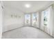 Spacious carpeted bedroom with ample natural light from three large windows at 10842 Rolling Moss Rd, Tampa, FL 33647
