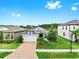 Inviting single-story home with brick driveway, lush green lawn, and a neatly landscaped front yard at 10842 Rolling Moss Rd, Tampa, FL 33647