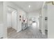 Hallway with wood-look floors that lead to the kitchen and other rooms at 10842 Rolling Moss Rd, Tampa, FL 33647
