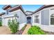 Close-up of home's entryway, showcasing brick pathway, blue door, and attached two-car garage at 10842 Rolling Moss Rd, Tampa, FL 33647
