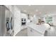 A spacious, bright kitchen with white cabinets, quartz countertops, and stainless steel appliances at 10842 Rolling Moss Rd, Tampa, FL 33647