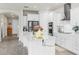 Bright kitchen featuring white cabinets, stainless steel appliances, and a spacious center island at 10842 Rolling Moss Rd, Tampa, FL 33647