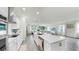 Bright open kitchen featuring an island, stainless steel appliances, and ample counter space flowing to the living room at 10842 Rolling Moss Rd, Tampa, FL 33647