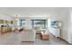 Spacious living area featuring an open floor plan with wood-look tile and natural light at 10842 Rolling Moss Rd, Tampa, FL 33647