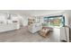 Bright living room area with an open floor plan to kitchen and dining at 10842 Rolling Moss Rd, Tampa, FL 33647