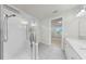 Modern main bathroom with glass-enclosed shower, white tile, and vanity at 10842 Rolling Moss Rd, Tampa, FL 33647
