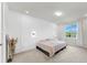 Cozy main bedroom with natural light, soft carpet, and minimalist decor at 10842 Rolling Moss Rd, Tampa, FL 33647