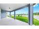 Covered patio showing serene green space beyond the white picket fence at 10842 Rolling Moss Rd, Tampa, FL 33647