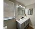 Stylish bathroom features a sleek vanity with modern fixtures, a well-lit mirror, and a minimalist design at 10914 Oakdale Ave, Port Richey, FL 34668