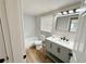 Well-lit bathroom featuring a tub with shower, sleek vanity, and mirror at 10914 Oakdale Ave, Port Richey, FL 34668