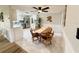Dining area with tile floors, wood table with chairs, kitchen access, stainless appliances, and bar seating at 10914 Oakdale Ave, Port Richey, FL 34668