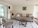 Bright living room features hardwood floors, neutral color scheme, and stylish decor for a welcoming atmosphere at 10914 Oakdale Ave, Port Richey, FL 34668